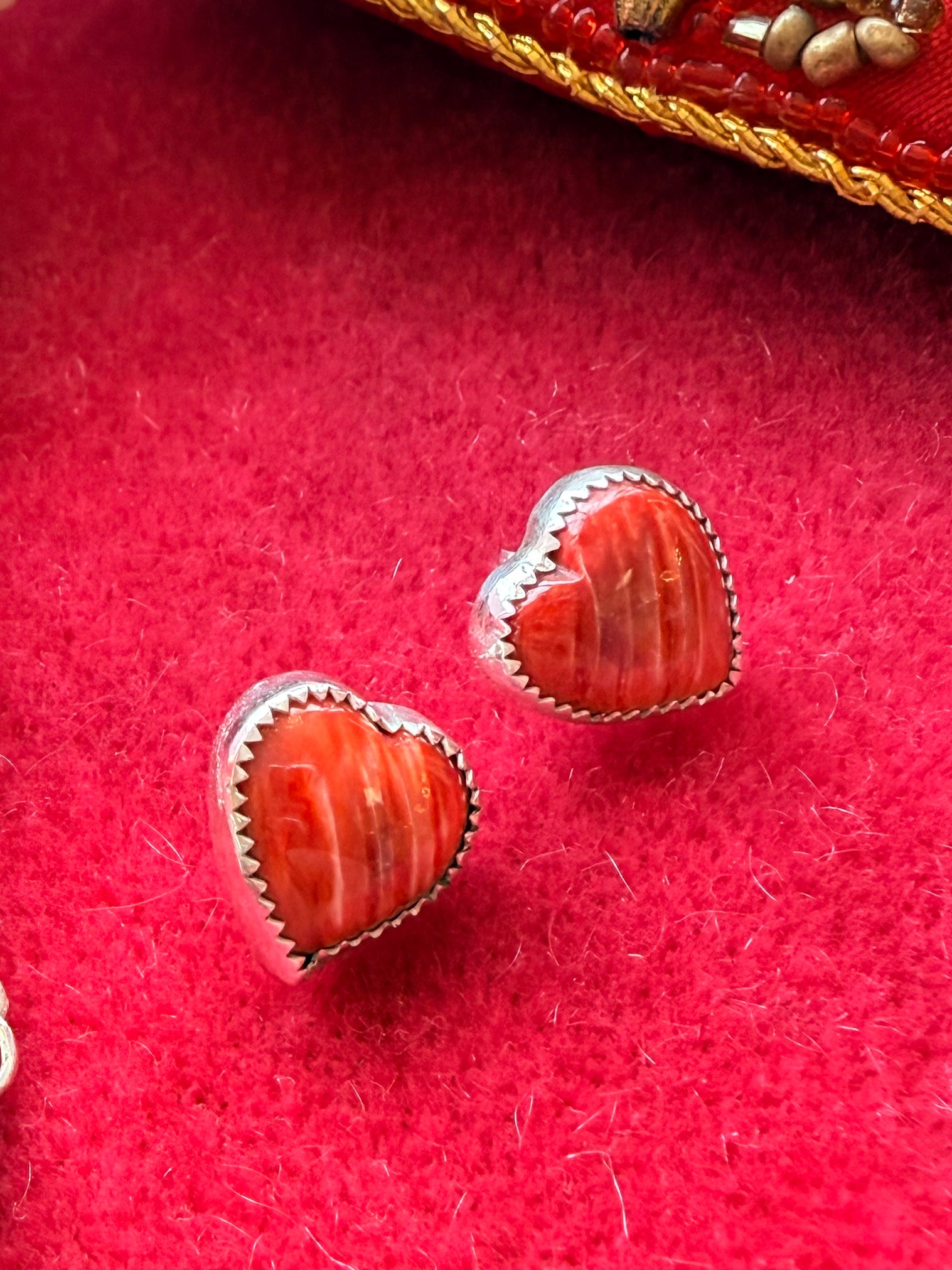 Red Pony Brand spiny oyster pink stones in sterling silver earrings on red background